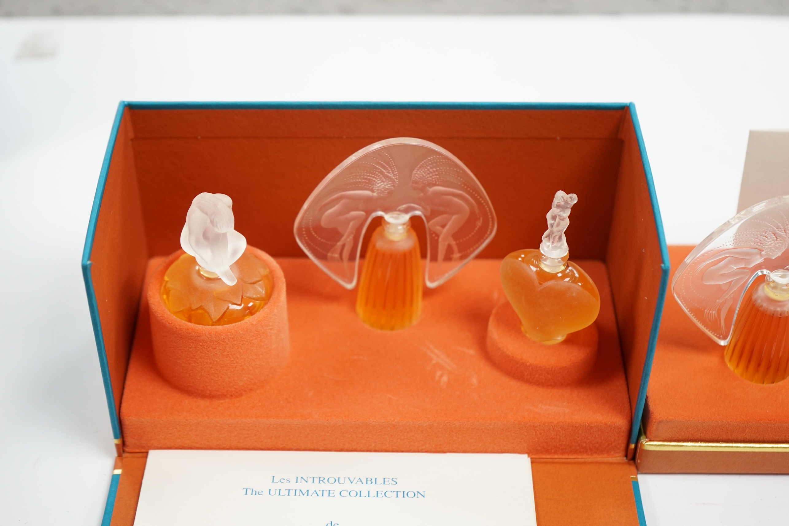 Two Lalique sets of three miniature perfume bottles. 'Les flacons miniatures' 1996-1997 and 1998-2000, boxed and sealed, tallest 7cm high. Condition - good